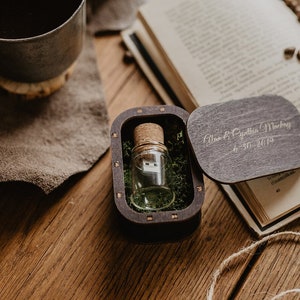 May include: A small wooden box with a glass vial containing a USB drive. The box is engraved with the text "Alan & Cynthia Mackey 4.30.2019".