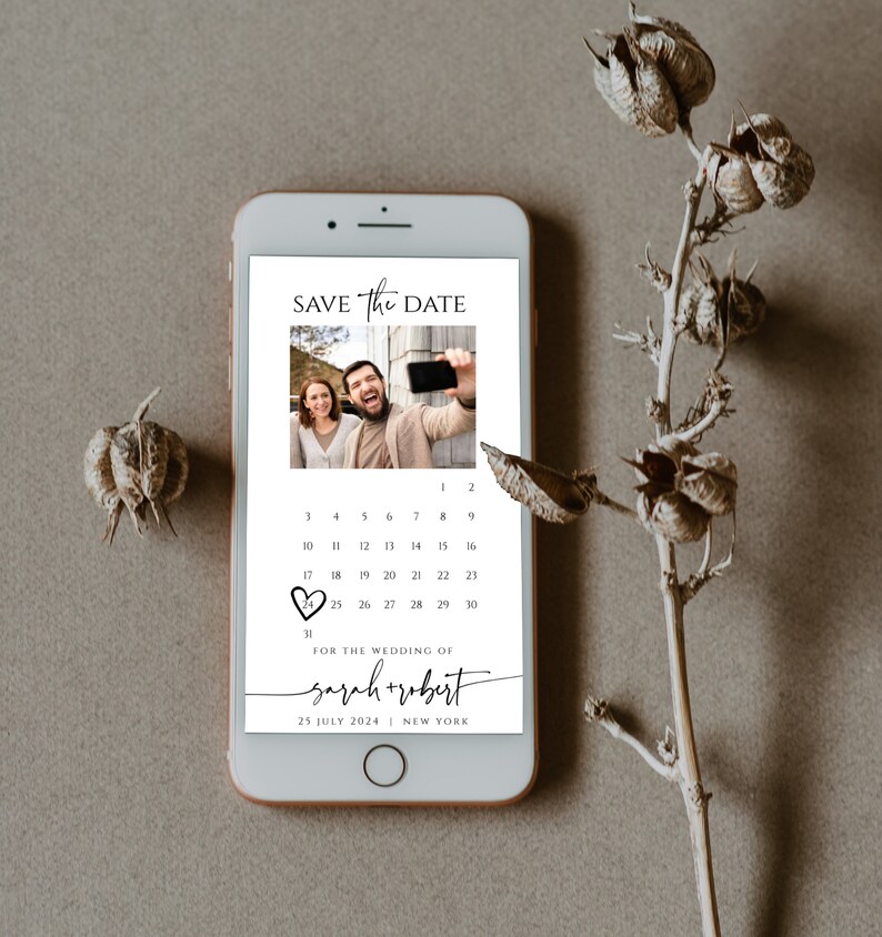 May include: A digital save the date card with a photo of a couple taking a selfie. The card features a calendar with the date circled in red and the text "SAVE The DATE" at the top. The text "FOR THE WEDDING OF sarah + robert" is below the calendar, along with the date "25 JULY 2024" and the location "NEW YORK".