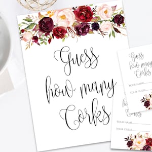 May include: A printable game card with a floral design in shades of burgundy, pink, and green. The card says "Guess how many corks" and has a space for guests to write their names and guesses.