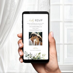 May include: A mobile phone screen displaying a wedding RSVP card with a green floral border. The card includes the couple's names, wedding website, and email address. A photo of the couple is also included.