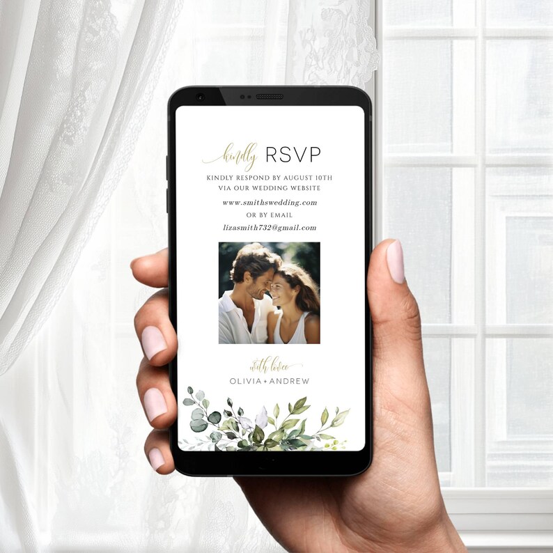 May include: A mobile phone screen displaying a wedding RSVP card with a green floral border. The card includes the couple's names, wedding website, and email address. A photo of the couple is also included.
