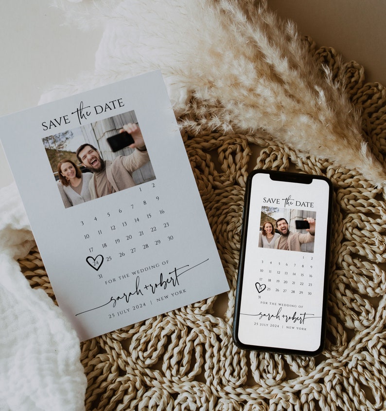 May include: Save the date card with a calendar and a photo of a couple. The card is white with black text and a heart shape. The text says "Save the Date" and "For the wedding of Sarah + Robert" with the date "25 July 2024" and location "New York".