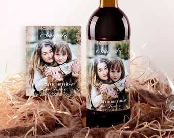 May include: A wine bottle label with a photo of two women hugging. The label is gold with glitter and says "Amanda" and "Happy 25th Birthday! Love Jessica".