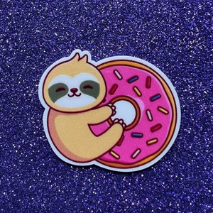 May include: A cartoon sloth holding a pink donut with colorful sprinkles. The donut has a white glaze and a hole in the center.