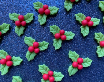 May include: A collection of green holly leaves with red berries. The leaves are arranged in a triangular shape with the berries in the centre.