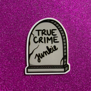 May include: A white tombstone sticker with black text that reads "TRUE CRIME junkie".
