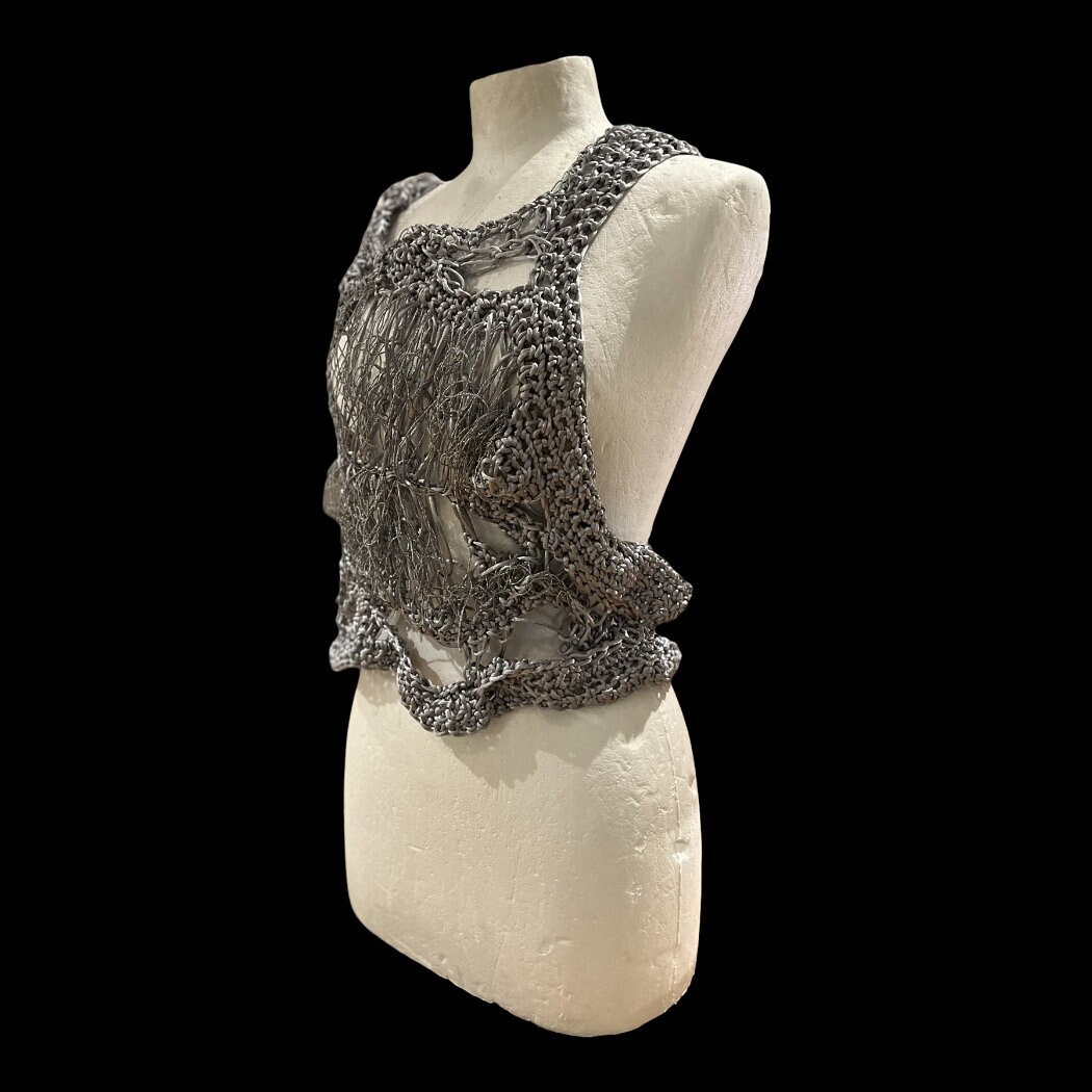 Postmodern fashion, crochet, futuristic silver vest, innovative fashion. Celebrity Fashion. dystopian costume. Conceptual Fashion.