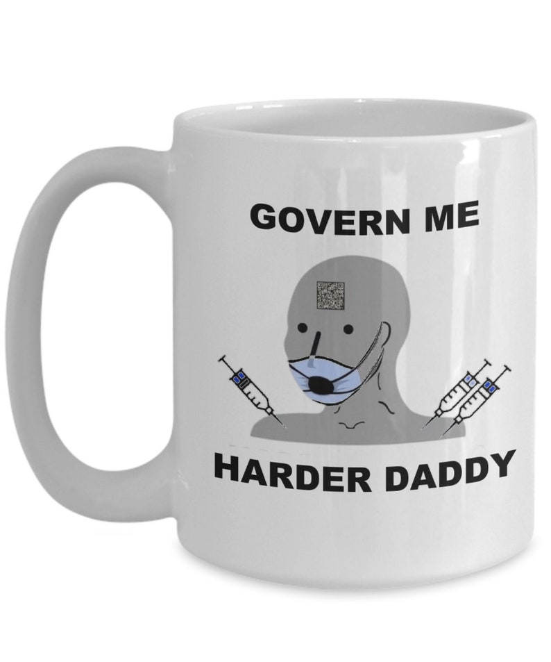 May include: White ceramic mug with a handle, featuring the text "GOVERN ME HARDER DADDY" in black. The mug has a cartoon image of a person wearing a face mask and holding syringes.