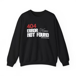 May include: Black sweatshirt featuring the text "404 ERROR Name NOT FOUND" in white and red. The text "REVELATIONS 20:15" is below the main text. The sweatshirt has long sleeves and a crew neck.