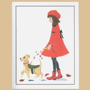 May include: A girl in a red coat and red hat walks with a small brown and white dog on a leash. The dog is wearing a green vest. The girl is holding a string of colorful hearts.