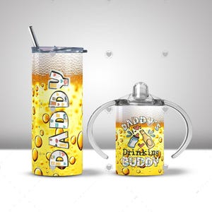 May include: A yellow tumbler with the word "DADDY" in a colorful font, and a matching sippy cup with the text "Daddy's Drinking Buddy". Both feature a beer-like design with bubbles.