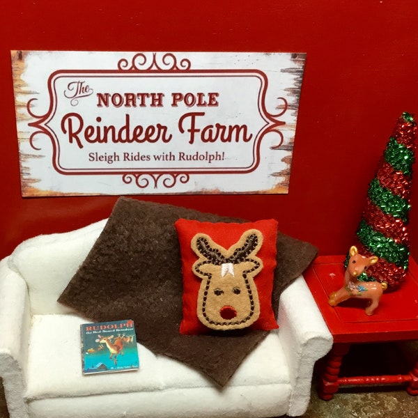 Dollhouse Miniature Reindeer Farm Sign, Rudolph Pillow, Brown Throw, Rudolph Book, Red & Green Tree. 1:12 Scale