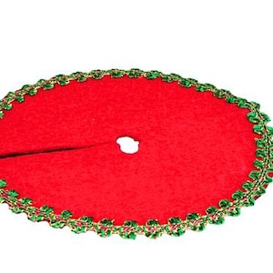 May include: Red velvet Christmas tree skirt with a green and gold trim.