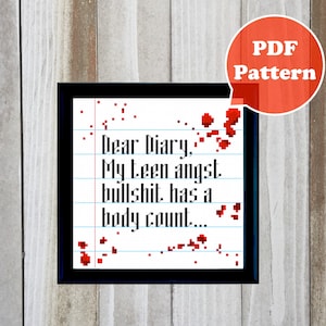 May include: Cross-stitch pattern with the text "Dear Diary, My teen angst, bullshit has a body count..." in black, with red accents. The design is on a lined paper background, framed in black, and includes a "PDF Pattern" label.