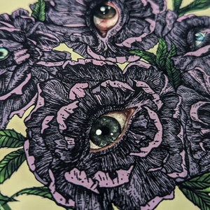 a hand drawn close up photo of a bouquet of duty purply flowers with photorealistic eyes at the centre of each with a soft green background.
