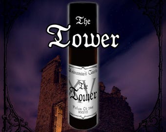 May include: A cylindrical perfume oil bottle with a black cap and a white label featuring the text Andromeda's Curse, The Tower, Perfume Oil 10ml, and MMXVII. The bottle is centered against a dark purple background with a stone tower silhouette.