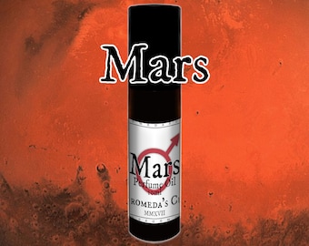 May include: A black glass bottle with a black label that says "Mars Perfume Oil 10ml ROMEDA'S G MMXVII" on a red and orange background.