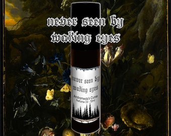 May include: A black bottle with a white label that reads "never seen by waking eyes" and "Andromeda's Curse Perfume Oil - 10ml". The label features a stylized forest scene. The bottle is sitting on a table with a dark green background.