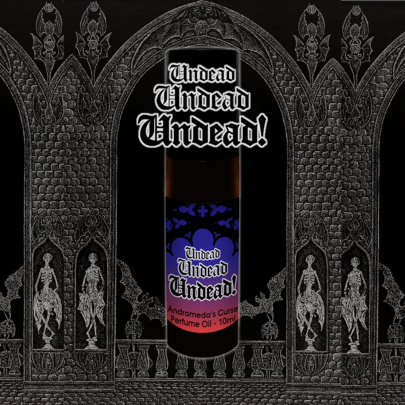 May include: A black glass bottle with a purple and black label that reads "Undead Undead Undead! Andromeda's Curse Perfume Oil - 10ml". The bottle is in front of a black and white gothic archway.