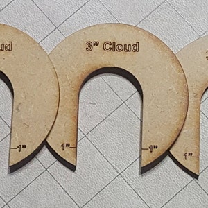 Puede incluir: Tres plantillas de nube de madera de 3 pulgadas con una abertura de 1 pulgada. Las plantillas están etiquetadas "3" Cloud".