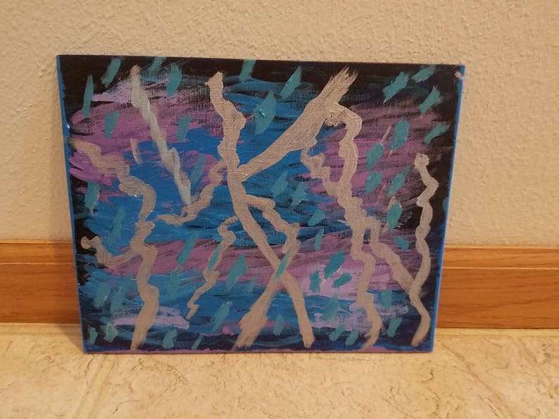 May include: Abstract painting on canvas with silver, blue, and purple paint. The painting features a series of lines and shapes that create a dynamic and energetic composition.