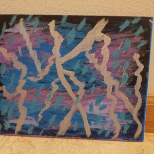 May include: Abstract painting on canvas with silver, blue, and purple paint. The painting features a series of lines and shapes that create a dynamic and energetic composition.