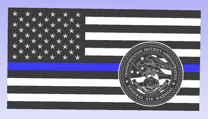 May include: A stylized American flag design with a blue stripe and a Transportation Security Administration Federal Air Marshal emblem. The flag features white stars on a black field and black and white stripes.