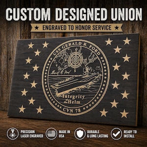 May include: A wooden plaque with the text "CUSTOM DESIGNED UNION" and "ENGRAVED TO HONOR SERVICE". The plaque features a detailed engraving of the USS Gerald R. Ford seal, stars, and the text "Integrity at the Helm". The plaque is laser engraved and made in the USA.
