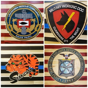 May include: Four wooden plaques with American flag designs. Each plaque features a different emblem: a navy blue and gold Undersea Rescue Command emblem, a red Military Working Dog emblem, a black and orange tiger emblem, and a blue Joint Improvised Explosive Device Defeat Organization emblem.