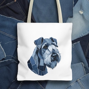 Puede incluir: Bolso tote blanco con un retrato de perro Schnauzer hecho de parches de mezclilla. La cabeza del perro está en tonos de mezclilla azul, con un asa color crema. El fondo es un collage de tela vaquera.