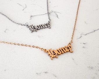 May include: Two gold and silver necklaces with the word "Honey" spelled out in a gothic font.