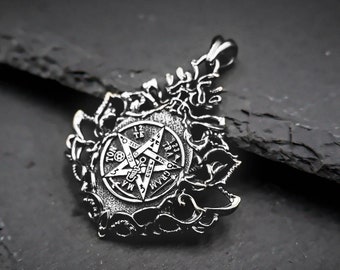 May include: Silver pendant featuring a pentagram with intricate details and a surrounding design of stylized leaves. The pendant is on a black background.