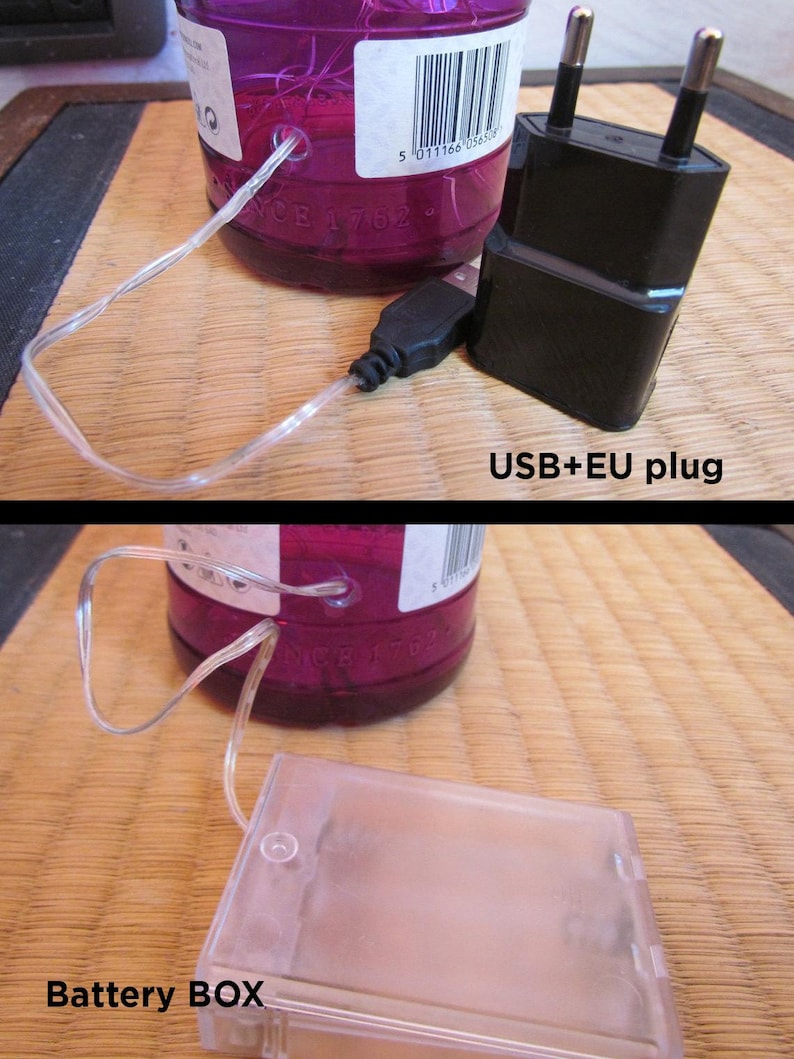 May include: A close-up of a purple glass bottle with a clear string of lights. A black USB plug and a black EU plug are visible. The text "USB+EU plug" is in the image. A clear battery box is also visible. The text "Battery BOX" is in the image.
