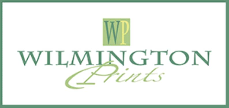May include: The image displays the text "WILMINGTON Prints" in a green, elegant font, with a stylized "Prints" in a cursive script. Above the text is a green square with the letters "WP" in a serif font.