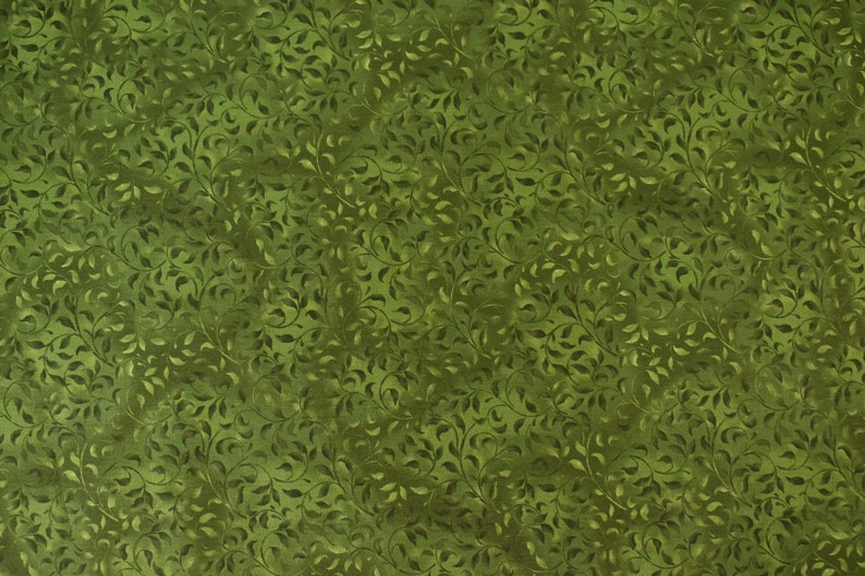 May include: A green fabric with a repeating pattern of small leaves and vines. The fabric has a subtle texture and a slightly faded look.
