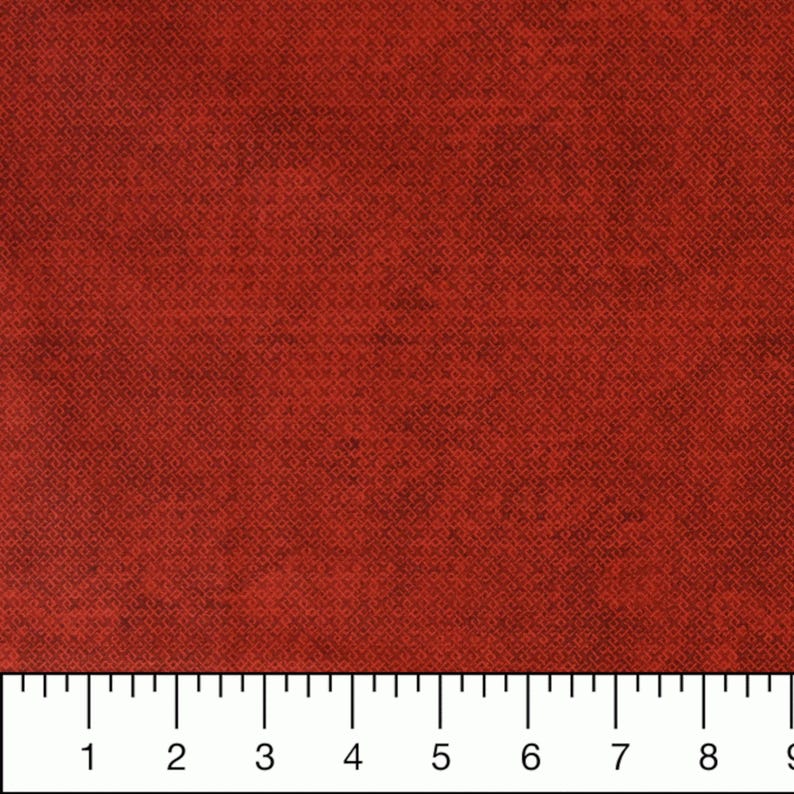May include: A close-up of a solid red fabric with a subtle textured pattern. The fabric is measured in inches.