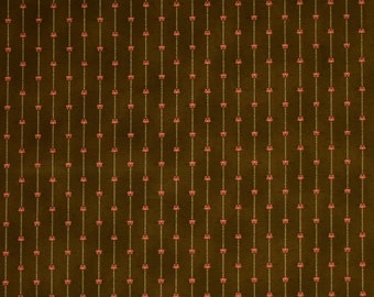 May include: A repeating pattern on a brown background. Vertical lines of small, light-colored dots are interspersed with lines of small, stylized red floral shapes. The overall effect is a textured, vintage-inspired design.