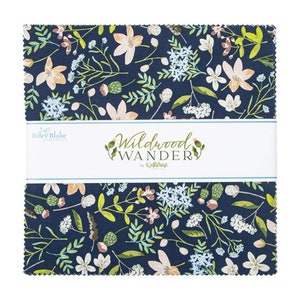 May include: A navy blue fabric square with a white label that reads "Wildwood Wander by Katherine  Englund". The fabric features a floral pattern with white, pink, and blue flowers and green leaves.