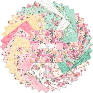 May include: A stack of square fabric swatches arranged in a circular fan pattern. The fabric features floral prints, geometric patterns, and polka dots in shades of pink, yellow, mint green, and white. A paper band labeled "Peony Blossom" wraps the center.
