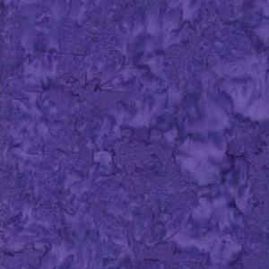May include: A close-up of a fabric with a mottled, tie-dye effect in shades of purple. The texture appears soft and slightly irregular, with lighter and darker areas creating depth and visual interest. The fabric is likely used for quilting or crafting.