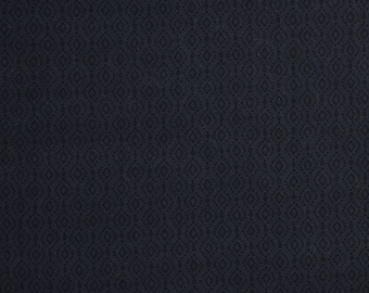 May include: A dark blue fabric with a repeating diamond pattern.