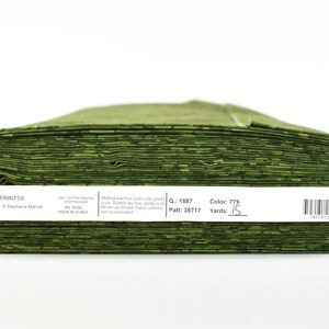 May include: A roll of green Wilmington Prints Essentials fabric, 15 yards long. The label reads "Color 779, Yards 15".