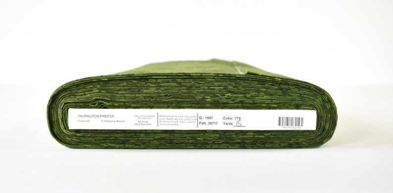 May include: A roll of green Wilmington Prints Essentials fabric, 15 yards long. The label reads "Color 779, Yards 15".