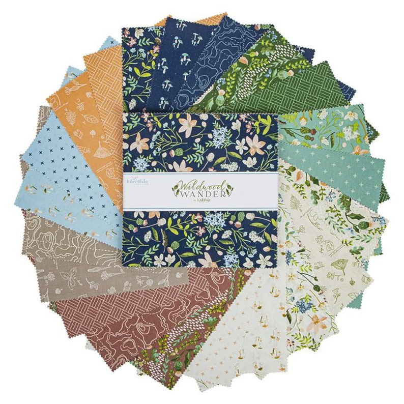 May include: A pack of 24 fabric squares featuring a variety of floral and nature-inspired patterns. The fabric squares are in shades of blue, green, brown, and cream. The pack is labeled "Wildwood Wander" by Riley Blake.