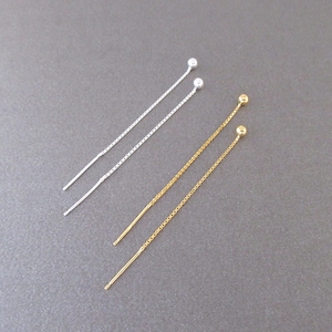May include: Two pairs of delicate chain earrings, one pair in silver and one pair in gold. Each earring features a small ball at the end of the chain.