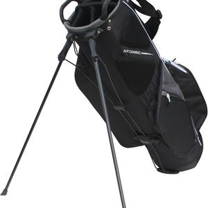 May include: Black golf bag with a stand. The bag has multiple compartments and a handle at the top. The text "AIR CHANNEL" is printed on the side. The stand legs are extended, ready for use.