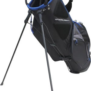 May include: Black and blue golf bag with a stand. The bag has a black body with blue accents around the top and pockets. The text "AIR CHANNEL" is printed on the side. The stand legs are extended.