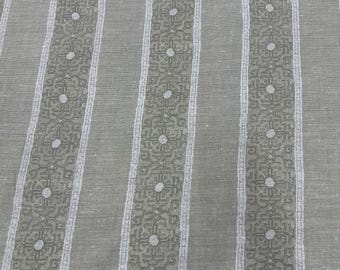 May include: Close-up of a fabric with a striped pattern. The design features vertical stripes in varying widths. The wider stripes are a muted gray, while the narrower stripes are a lighter gray with a repeating floral pattern and dotted accents. The fabric has a textured appearance.