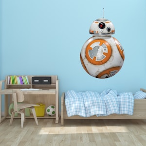 May include: A white and orange robot character with a round body and a single eye. The robot is on a blue wall above a wooden desk and a bed with a blue and white checkered bedspread.