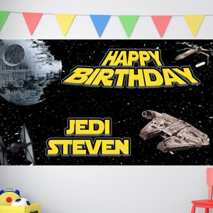 May include: A black and yellow Star Wars themed birthday banner with the text "Happy Birthday" and "Jedi Steven". The banner features images of the Death Star, a TIE fighter, and the Millennium Falcon.